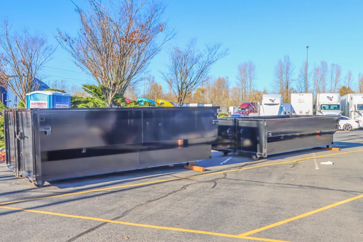 Professional dumpster rental service with roll-off container on residential driveway in Chalmette